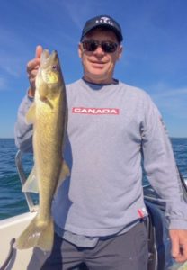 A happy customer with a great walleye.