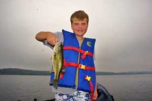 Young man with a Largemouth bass caught on a Hackensack area lake