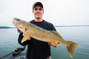 A happy client with a great afternoon walleye on one of the Whitefish area lakes